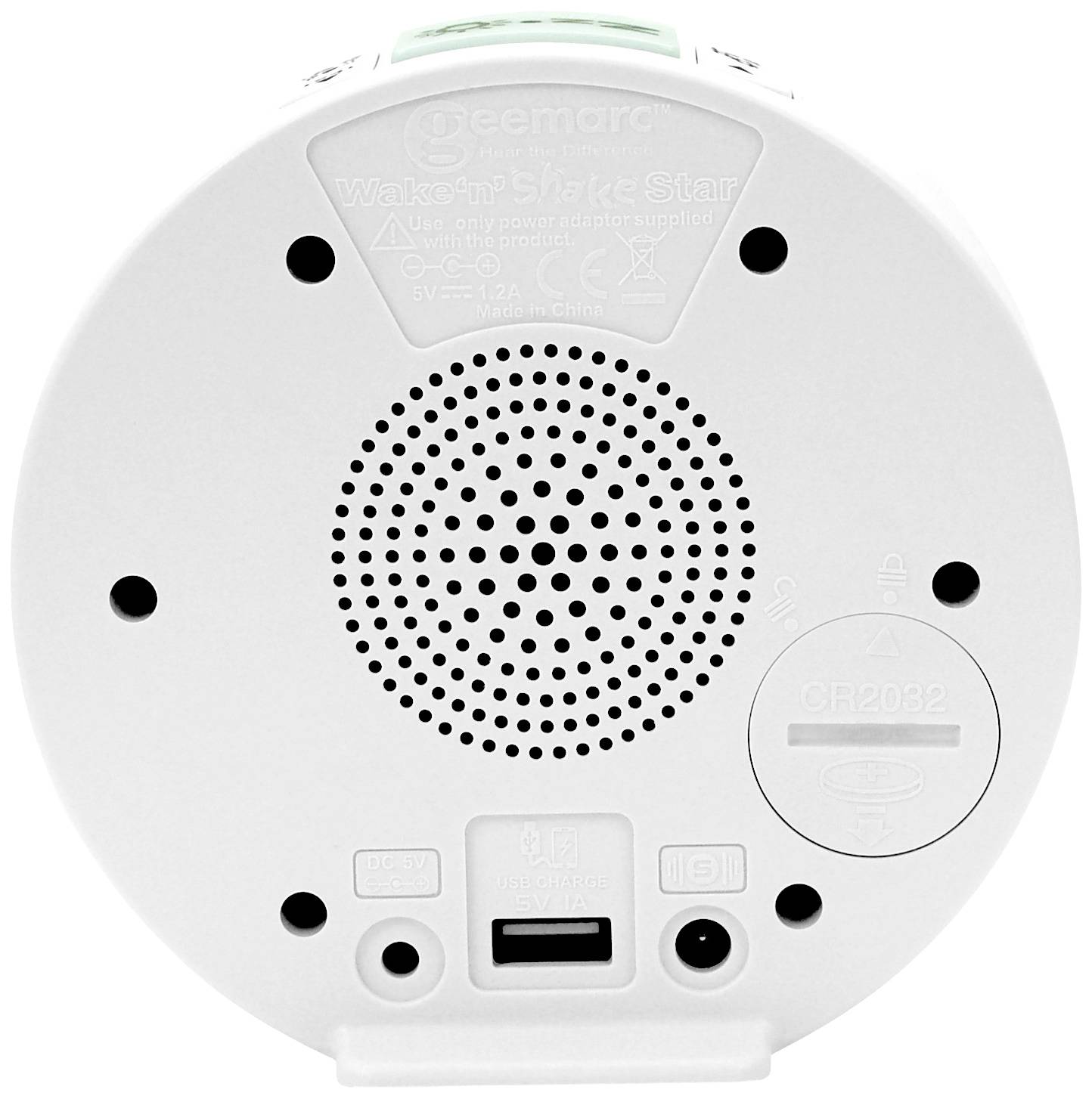 The back of a white alarm clock with a speaker grille, USB port, battery compartment, and several round buttons.
