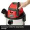 Vacuum cleaner with accessory holder; a hand inserts a nozzle. Function: easy storage of nozzles.