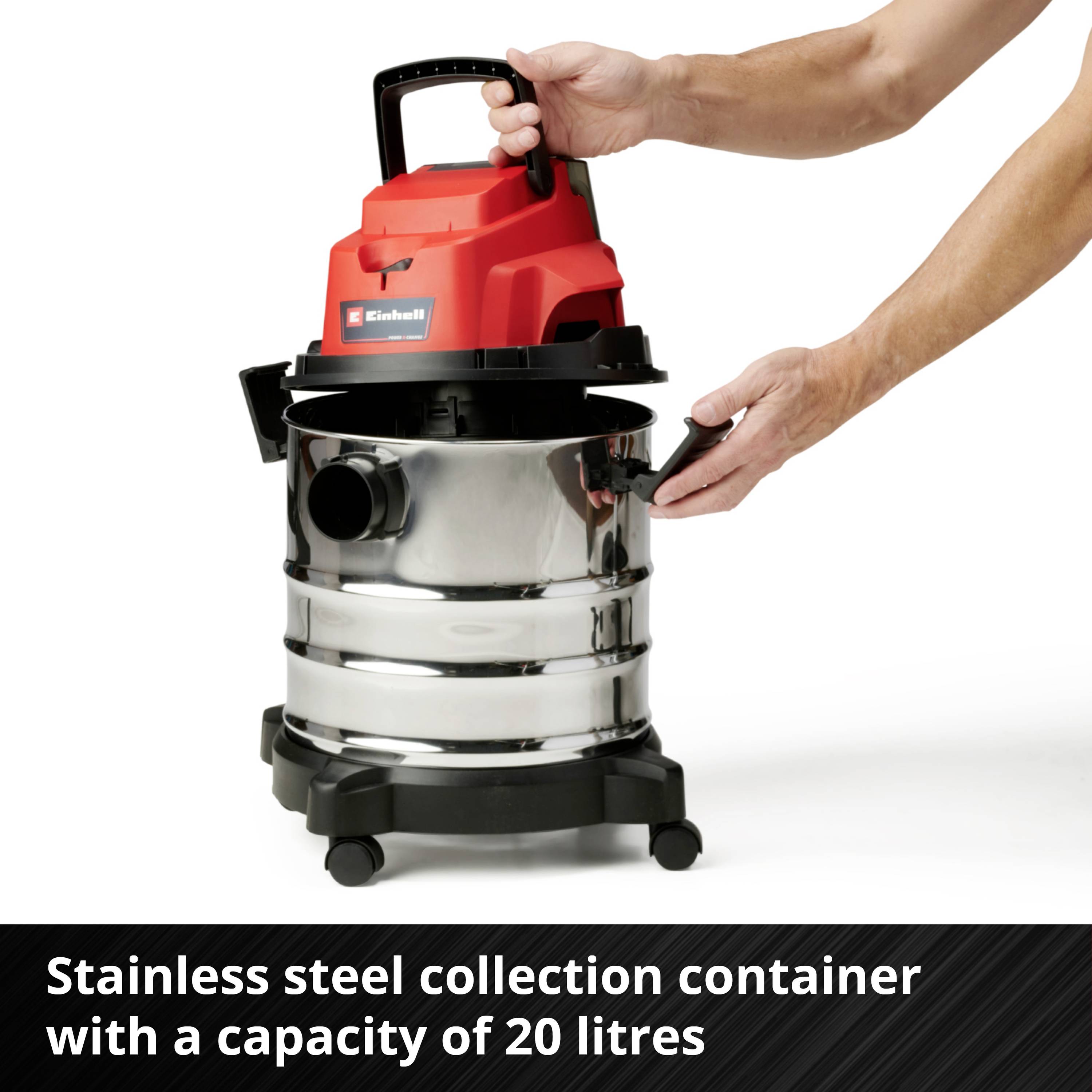 A person is holding an industrial vacuum cleaner with a stainless steel container; its capacity is 20 litres.