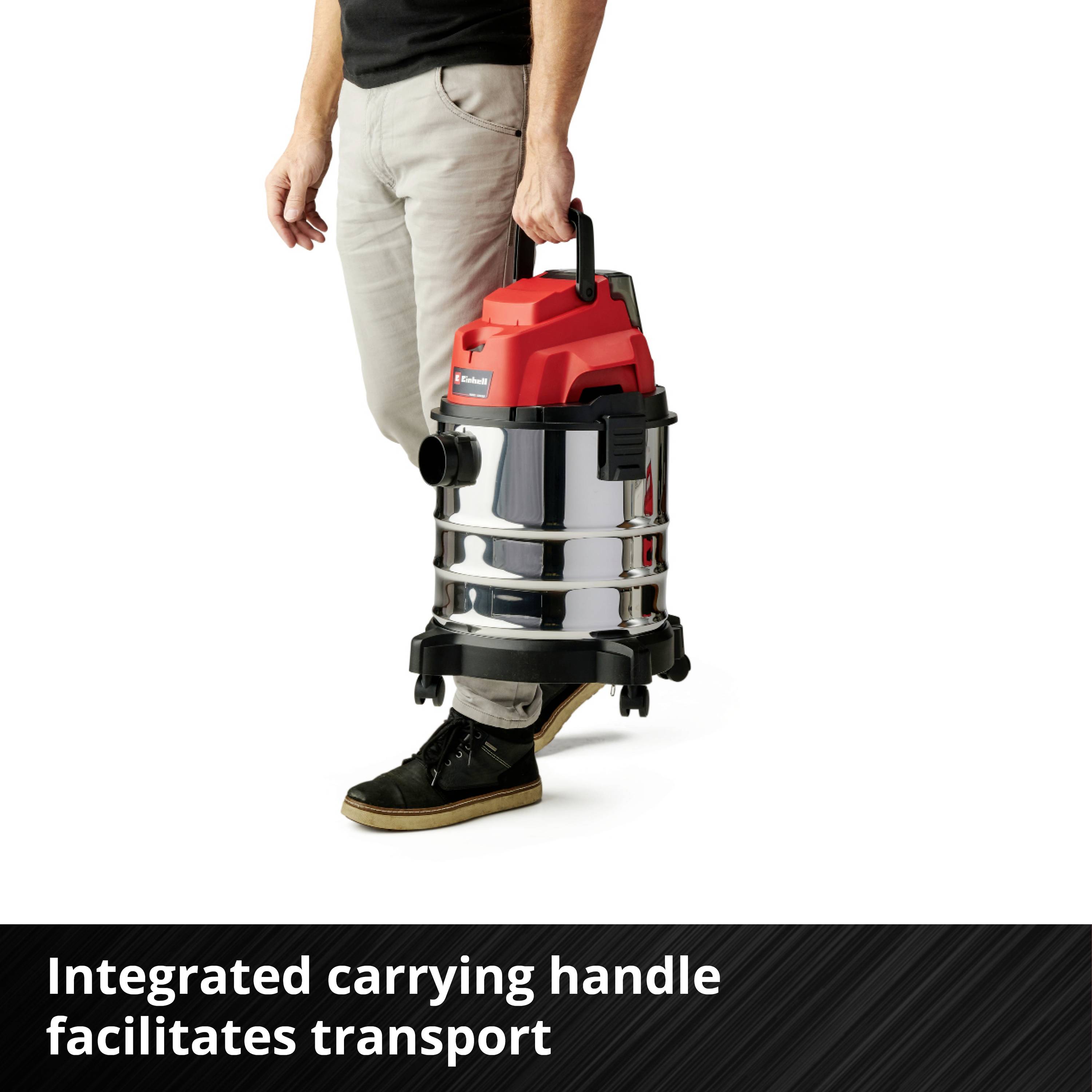 A person is holding a silver and red vacuum cleaner with an integrated carry handle. Text: 'Integrated carry handle makes transportation easier'.