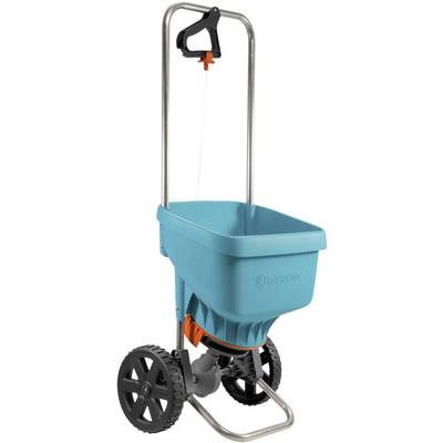 A blue spreader with a metal handle and two large black wheels. Suitable for distributing fertiliser or seeds in the garden.