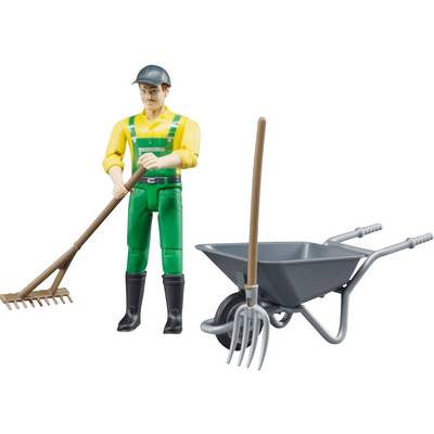 Toy figurine of a male gardener with a rake and wheelbarrow. The gardener is wearing a yellow shirt, green dungarees, and a hard hat.