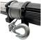 An electric winch with a metallic hook and cable drum. Suitable for lifting and pulling tasks, robustly constructed.