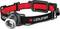 A black LED head torch with a red inner band. The head torch has an adjustable strap and a large lens at the front.
