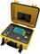 A yellow electrical measuring device with an open lid displays readings on a digital display. Various connection sockets are visible.