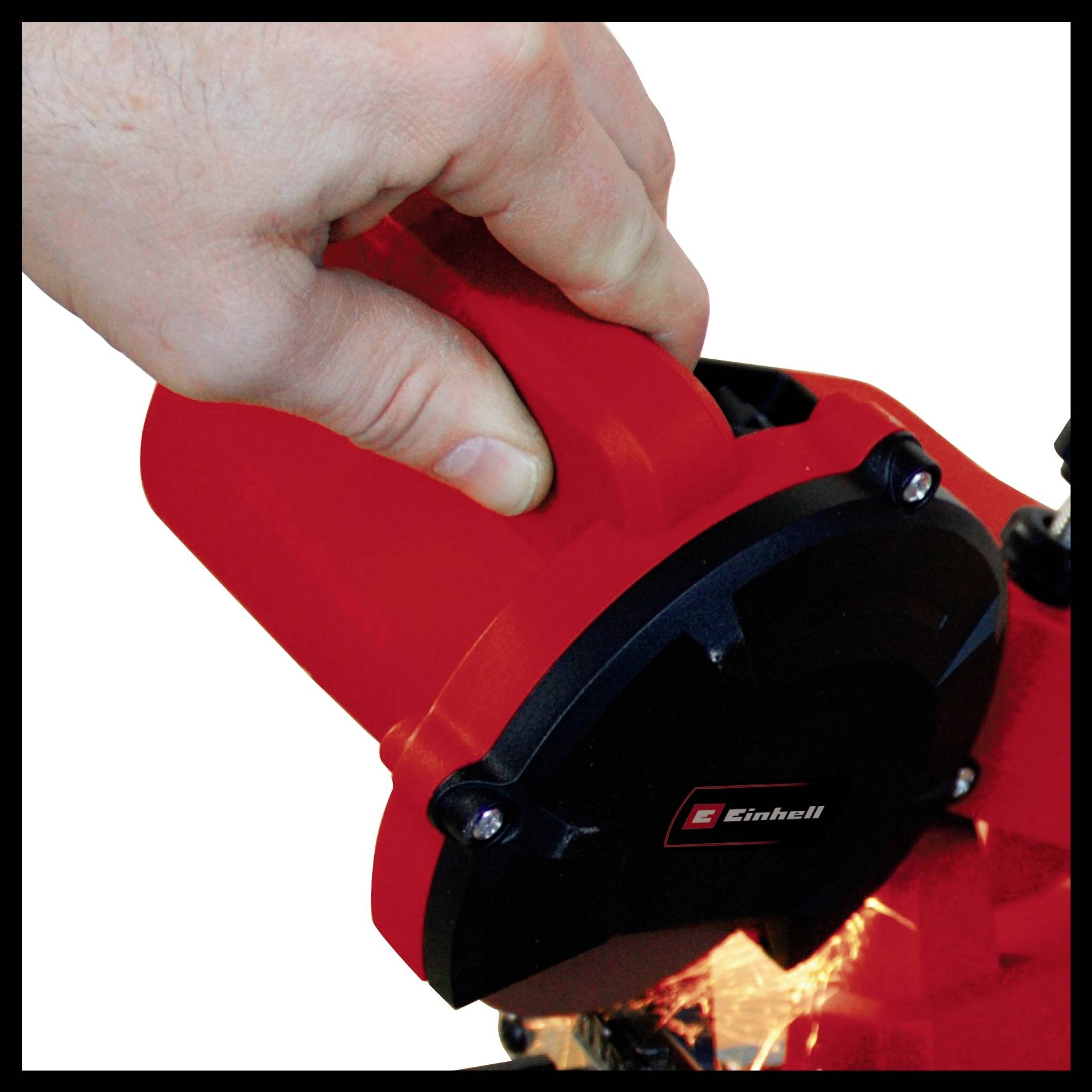 A hand holds a red angle grinder in operation, sparks spraying from the work area. The tool bears the logo of a tool brand.