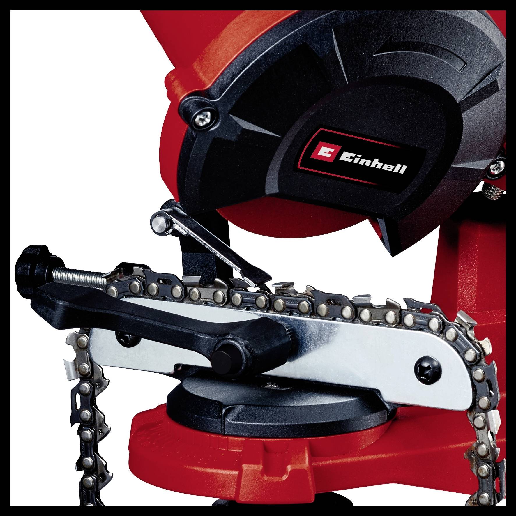 'Electric chainsaw sharpener by Einhell in red and black. Device in use for maintaining a chainsaw.'