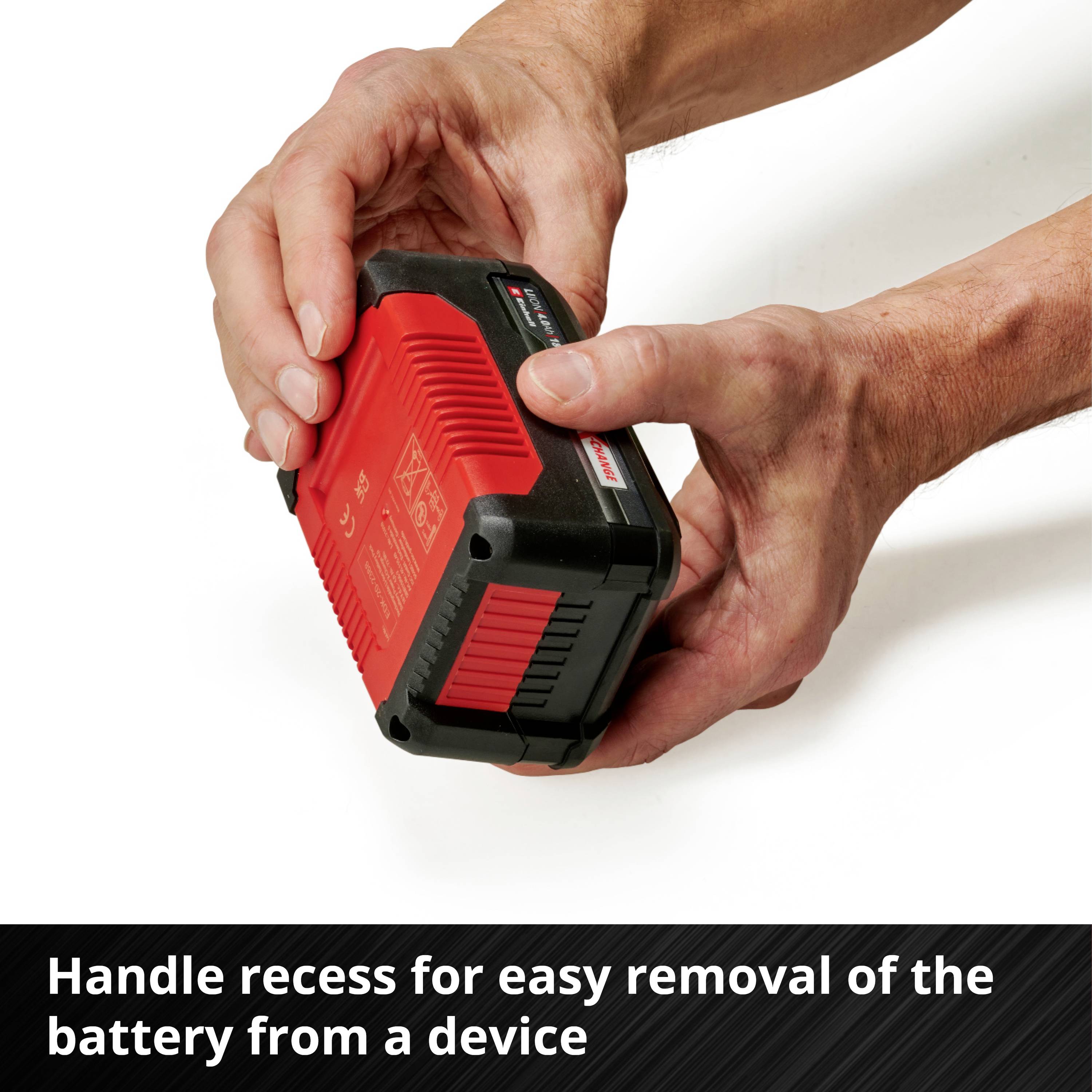 The image shows two hands holding a red battery with a black casing. Text: 'Grip recess for easy removal of the battery from a device'.