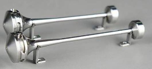 Two silver aerodynamic models on stands in a wind tunnel, used for drag resistance tests.