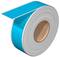 A large roll of blue self-adhesive material with a white paper backing, showing a section of the peeled blue adhesive.