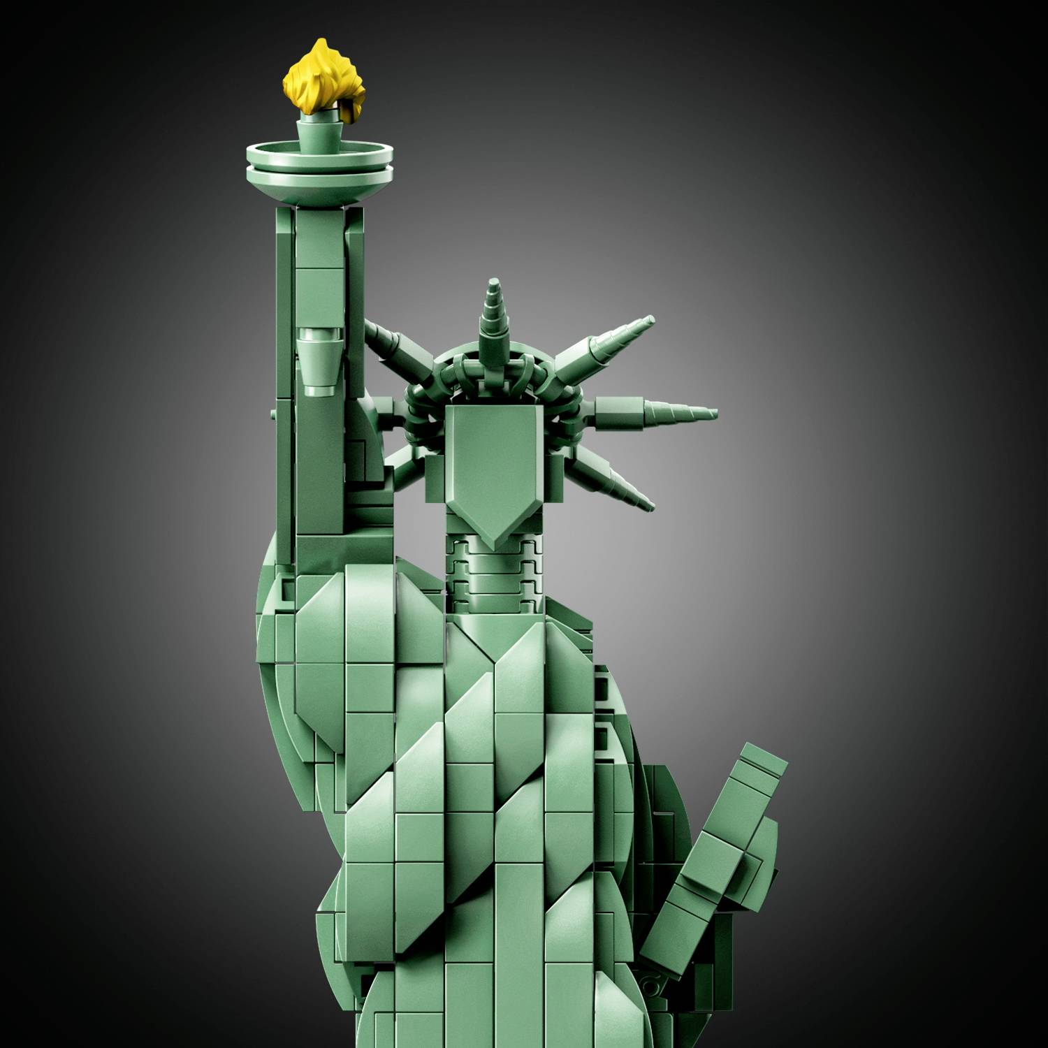 The Statue of Liberty constructed from green building blocks, holding a torch with a golden flame, against a neutral background.