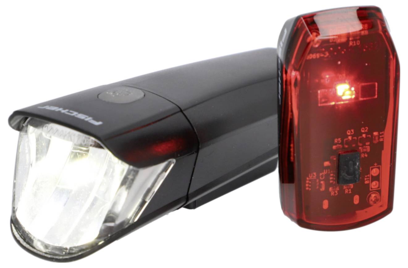 A pair of bicycle lights, one black with a white front light and one red with a red rear light, designed for visibility and safety.