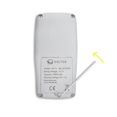 Device with a plastic housing, showing the rear side with model and manufacturing details; yellow arrow points to an antenna.