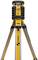 A yellow laser level on an aluminium tripod, used for precise height measurements in construction projects.