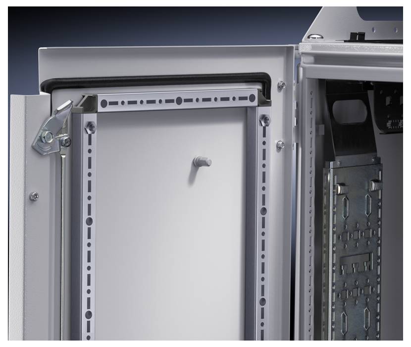 An opened electrical cabinet with visible metal hardware components and multiple mounting elements.