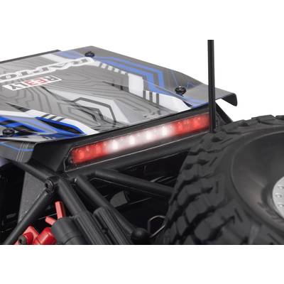 Close-up of a remote-controlled car with chunky profile tyres and a glowing red LED strip on the rear.