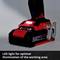 A cordless drill with a red casing is partially illuminated. An LED light at the base ensures better visibility when working.