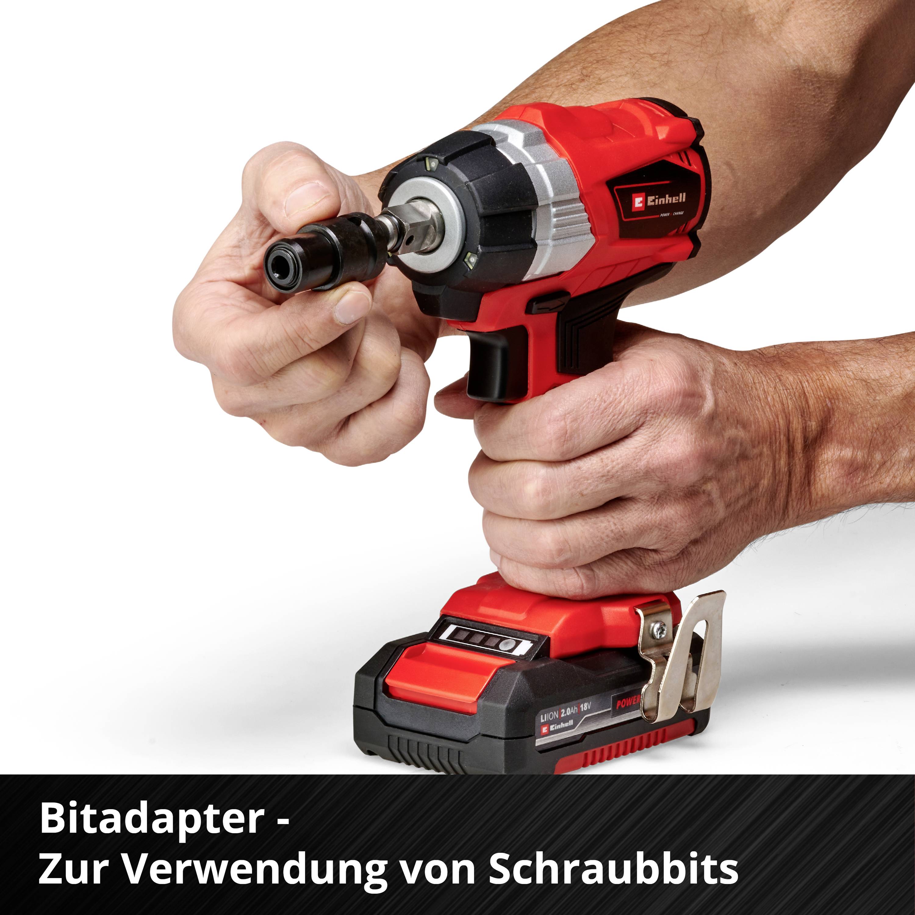 A person is using a red cordless screwdriver with a bit adapter, suitable for screw fastening work.