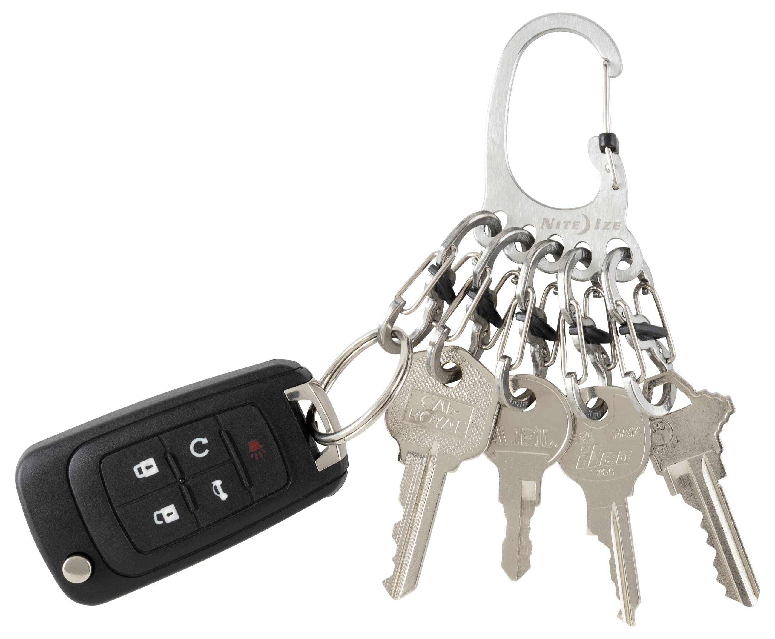 A set of six metallic keys on a keyring, attached to a black car key fob with four buttons, including lock and unlock icons.