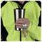 A person in a high-visibility jacket holds a stainless steel travel mug and a keyring with several keys attached.