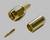 A coaxial plug consisting of three parts: a gold-plated connector, a sleeve, and a small pin.