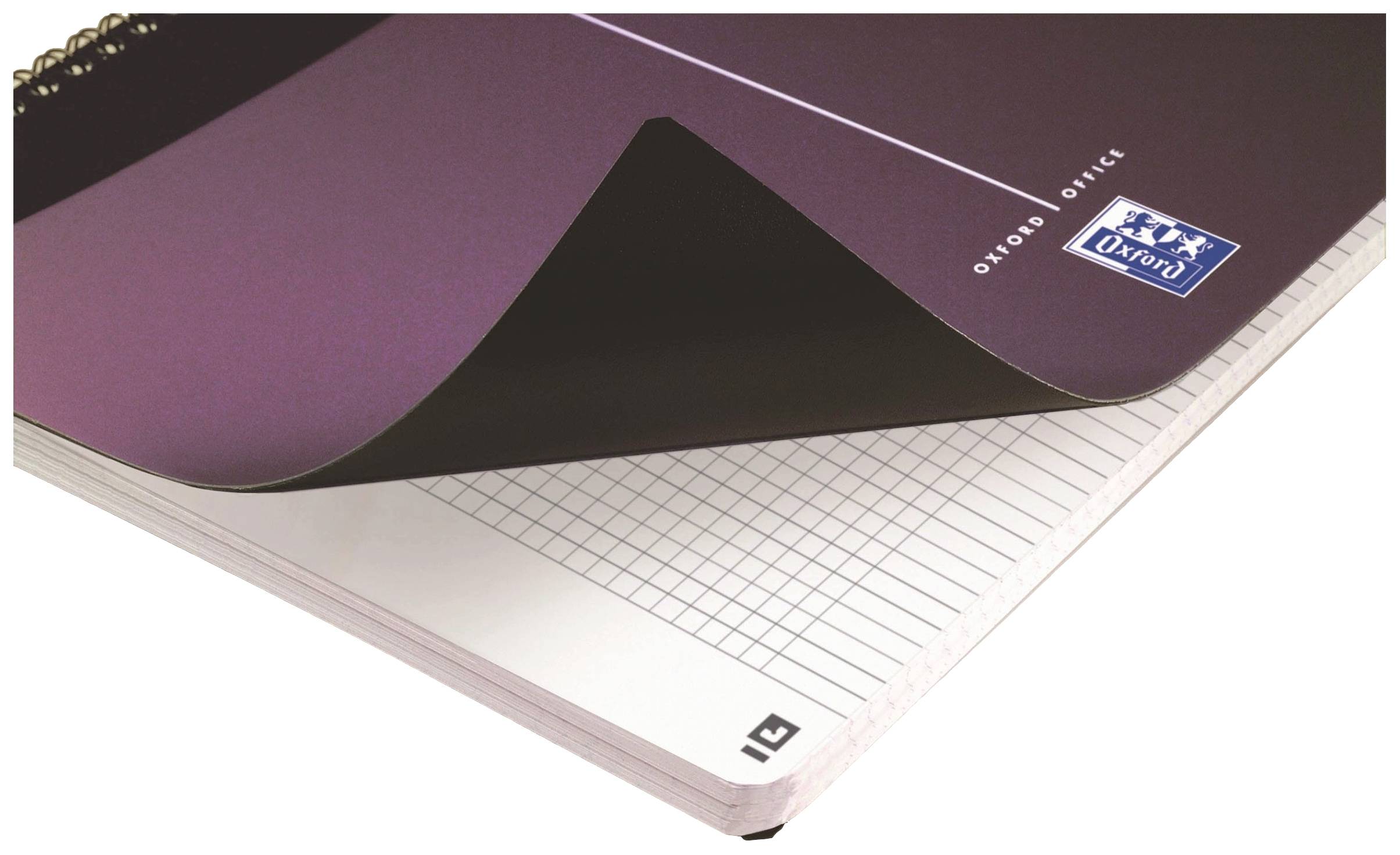 A ring-bound pad with a purple cover, open to a page with squared paper. Brand logo and inscription 'Oxford Office' visible.