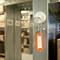 A bunch of keys hangs on a metal hook with an orange tag that reads 'STORAGE'. Shelves can be seen in the background.