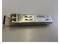 A Siemens SFP module is resting on a surface. It is an optical transceiver module used for network connections.