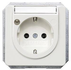 A white, European socket by Siemens, mounted in a metallic-framed wall plate.