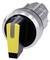A black rotary knob with a yellow handle and silver frame, likely a switch or control for technical equipment.