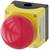 A large red emergency stop button on a yellow housing, used for quickly shutting down machinery in emergency situations.