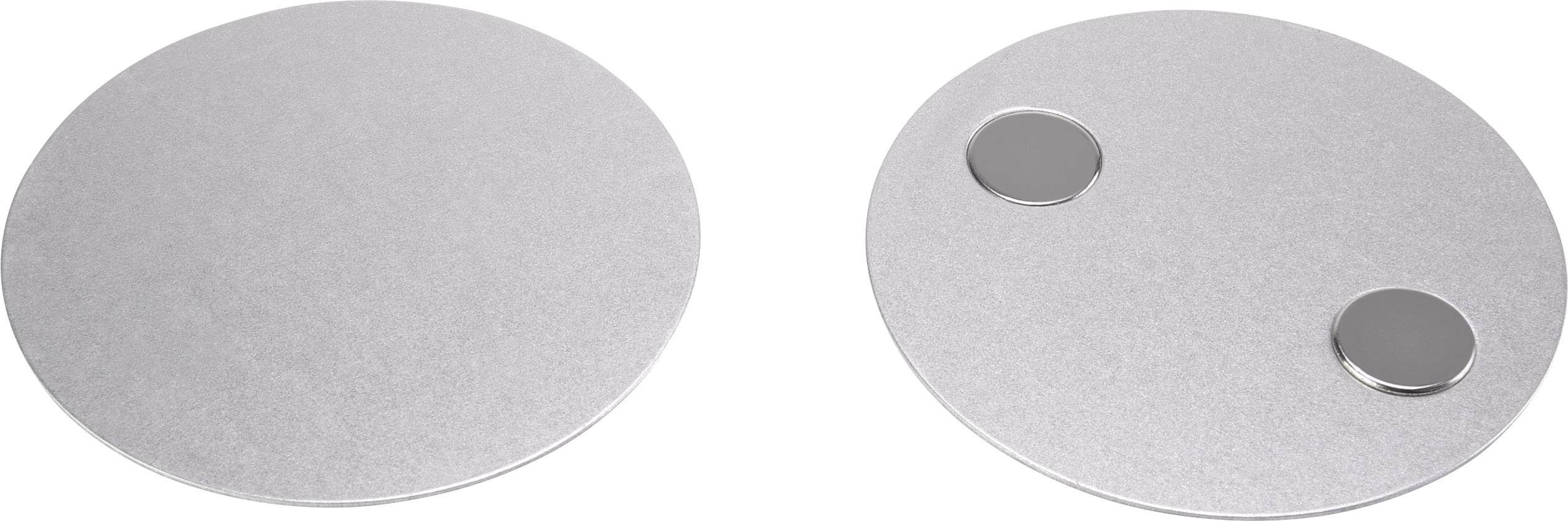 Two round silver plates side by side; the one on the right has two small raised circles on it.