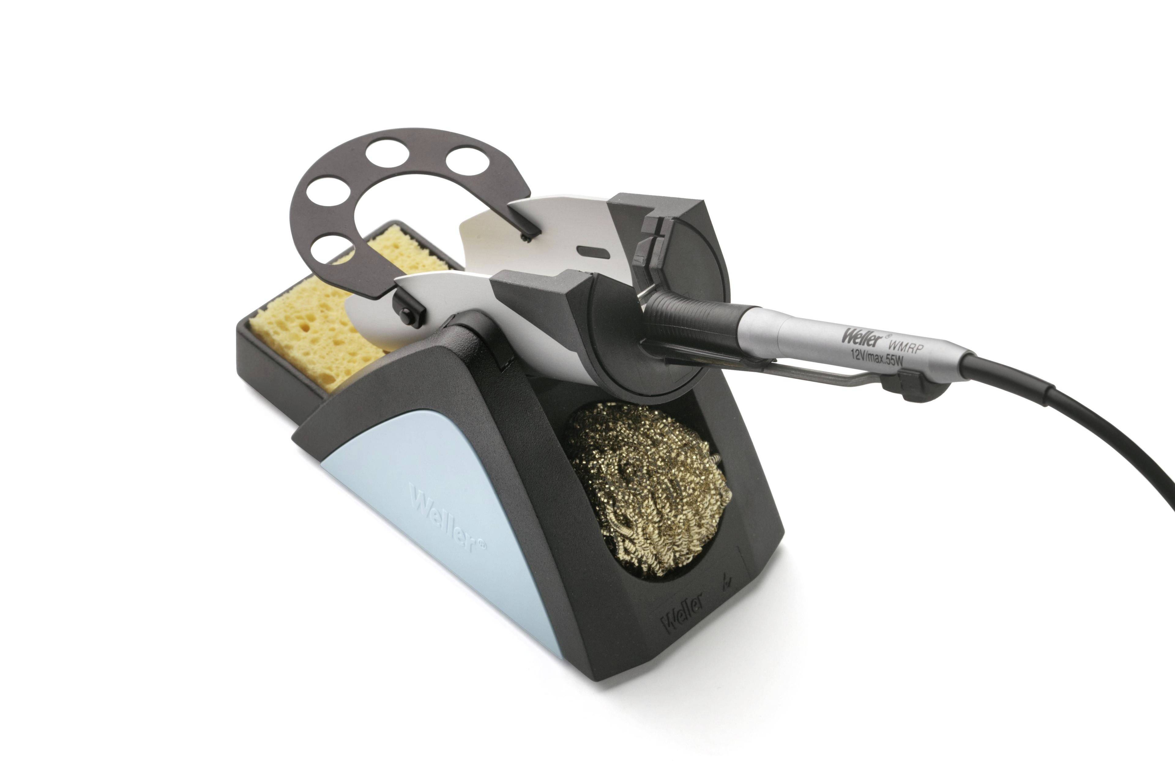 Soldering iron with stand showing the 'Weller' brand. Pictured with cleaning sponge and metal wool, for soldering electronic components.