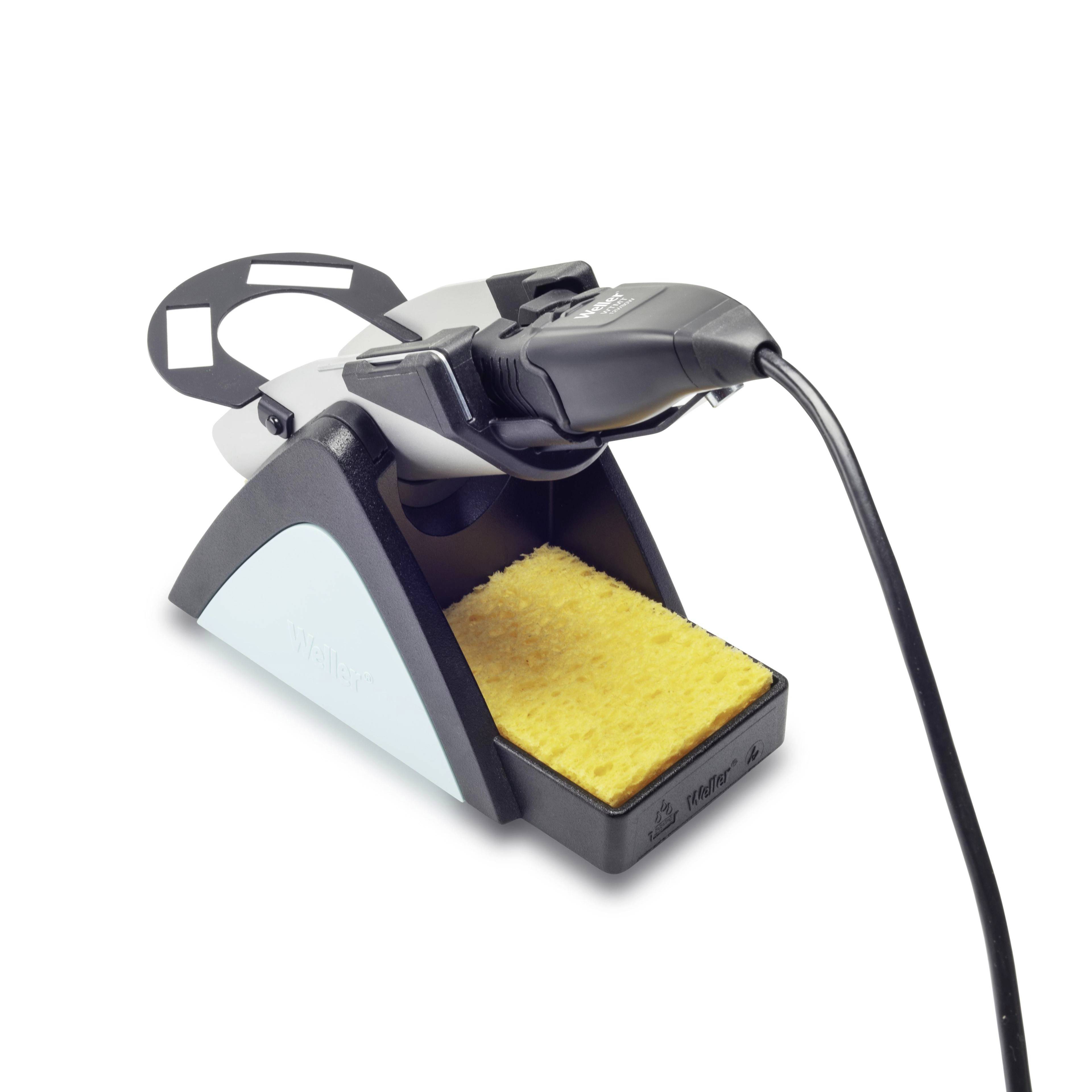 Soldering iron stand with integrated cleaning block and power cable for soldering work, including a sponge for cleaning the iron tip.