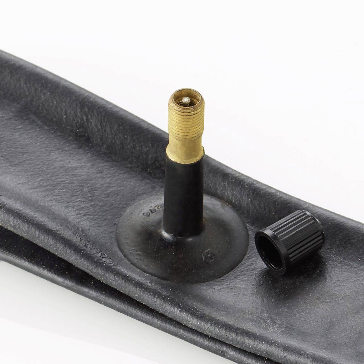 Image of a bicycle inner tube with a gold valve and removable valve cap on a white background.