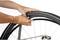 A person is repairing a bicycle tyre by checking the inner tube.