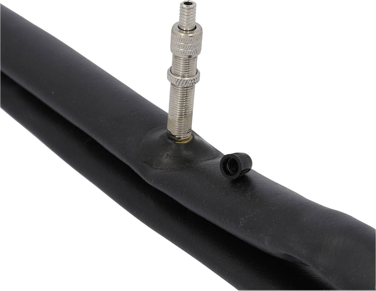 A bicycle inner tube with a silver valve and a black screw cap.
