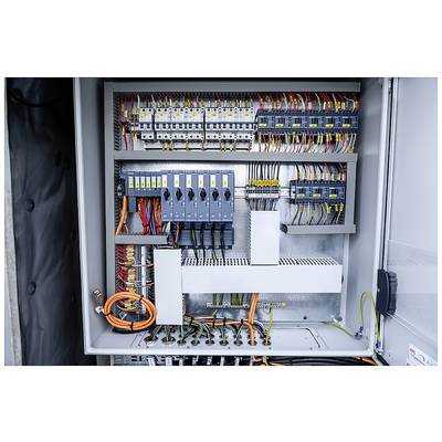 Electrical control cabinet with open doors reveals wires, fuses, and switches in various colours and sizes.