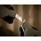 A person wearing gloves is changing the blade of a Stanley knife. Background blurred, focus on hands and blade.