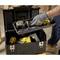A person is arranging tools in an open toolbox. A tape measure, a spirit level, and yellow power tools are visible.