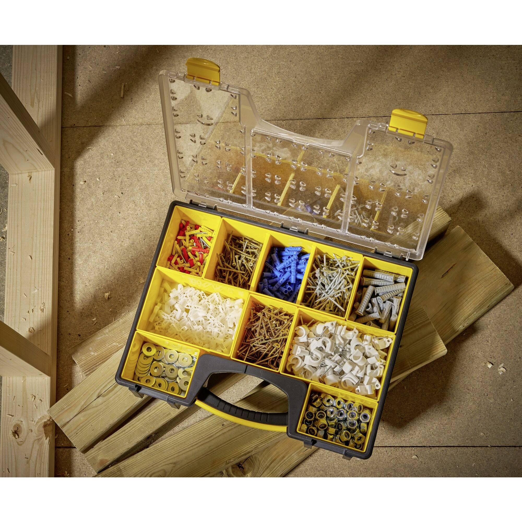 'Organised tool kit with screws, nails and wall plugs on wooden floor, within easy reach for DIY projects.'