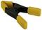 Plastic spring clamp with yellow handles and black metal components. Used for holding or gripping objects.
