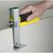 A hand holds a tool used for precisely cutting plasterboard.