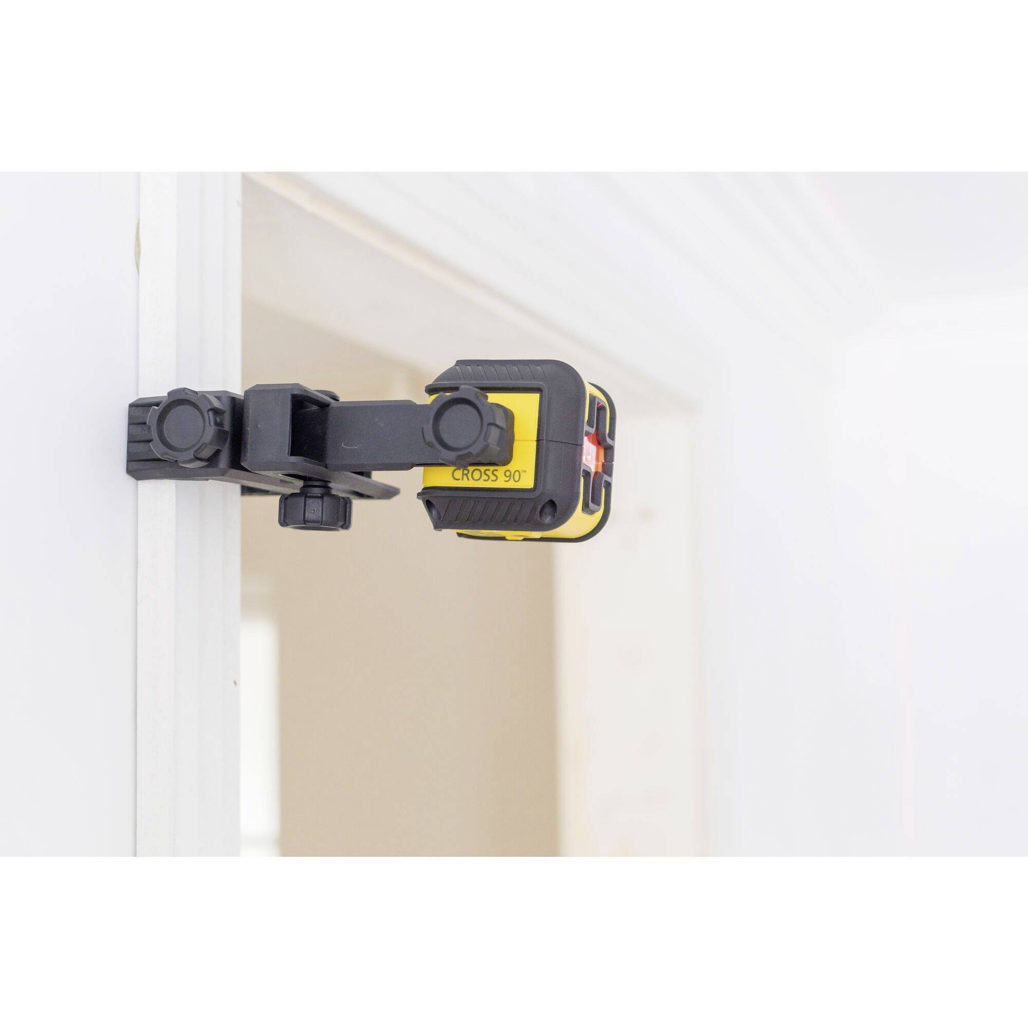 Laser spirit level attached to the door frame, aligned for precise measurements.