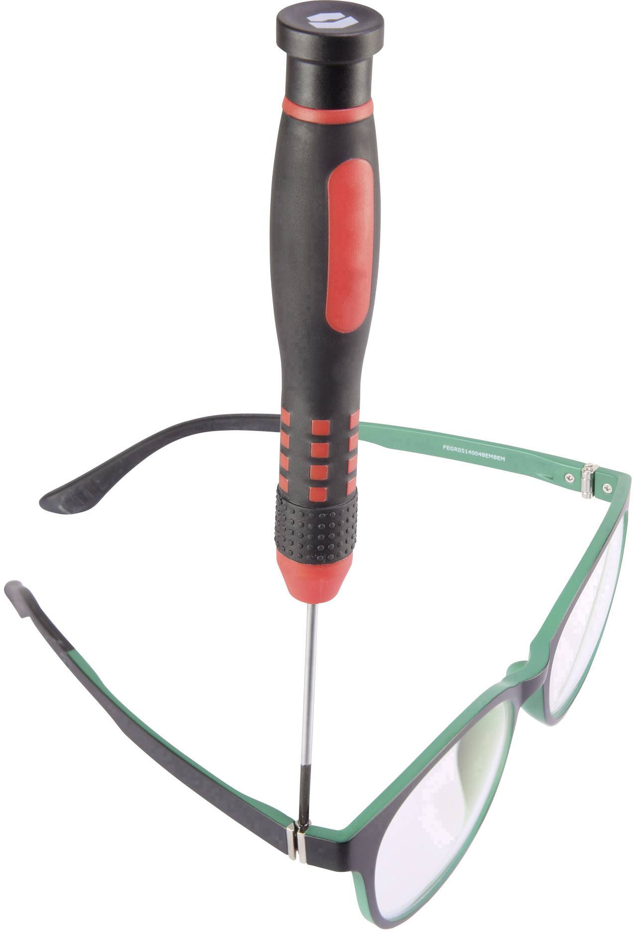 A screwdriver is being used to repair a green pair of glasses; it is securing the hinge of the spectacle frame.