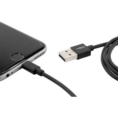 A smartphone is connected to a charger via a USB cable. The focus is on the connection that enables the device to be charged.