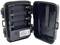 Opened battery compartment lid of a trail camera with space for batteries and control elements inside.