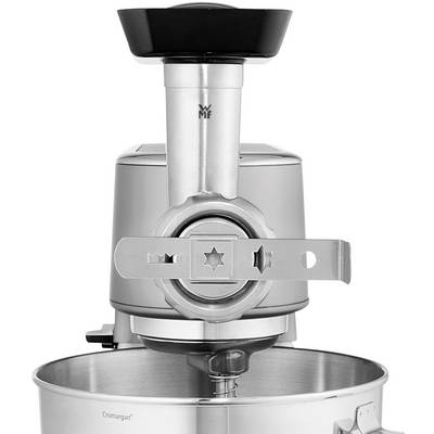 Silver kitchen mixer with a large bowl in the foreground. A cutting attachment is fitted to the machine.