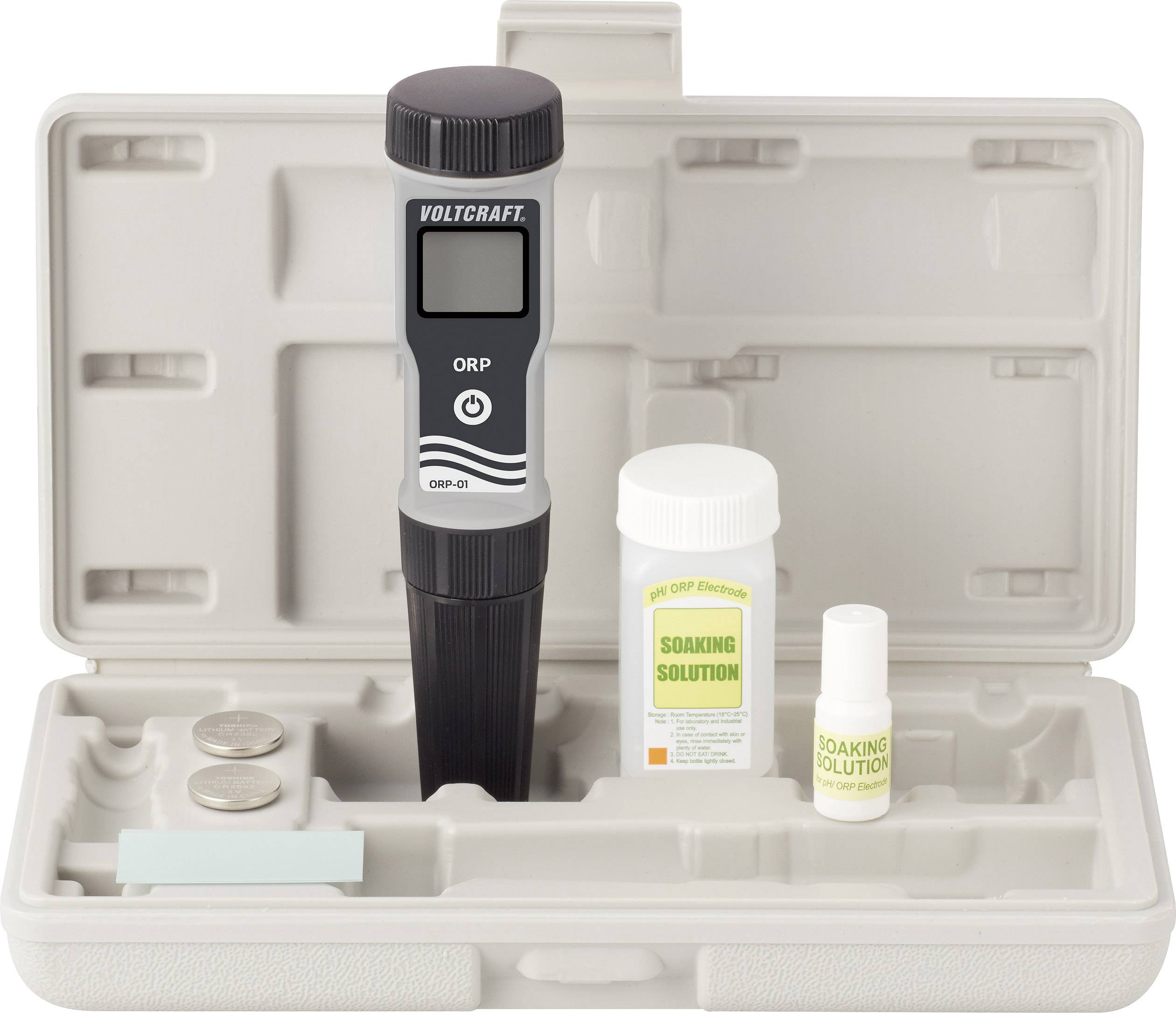 ORP meter in an open case. Contains the device, batteries and two bottles of 'Soaking Solution'.
