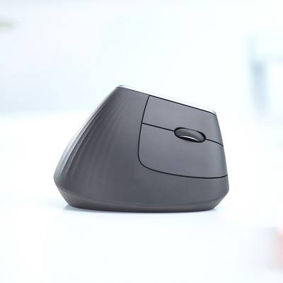 A black, vertical ergonomic mouse on a table. It has a unique, angled design and a visible scroll button.